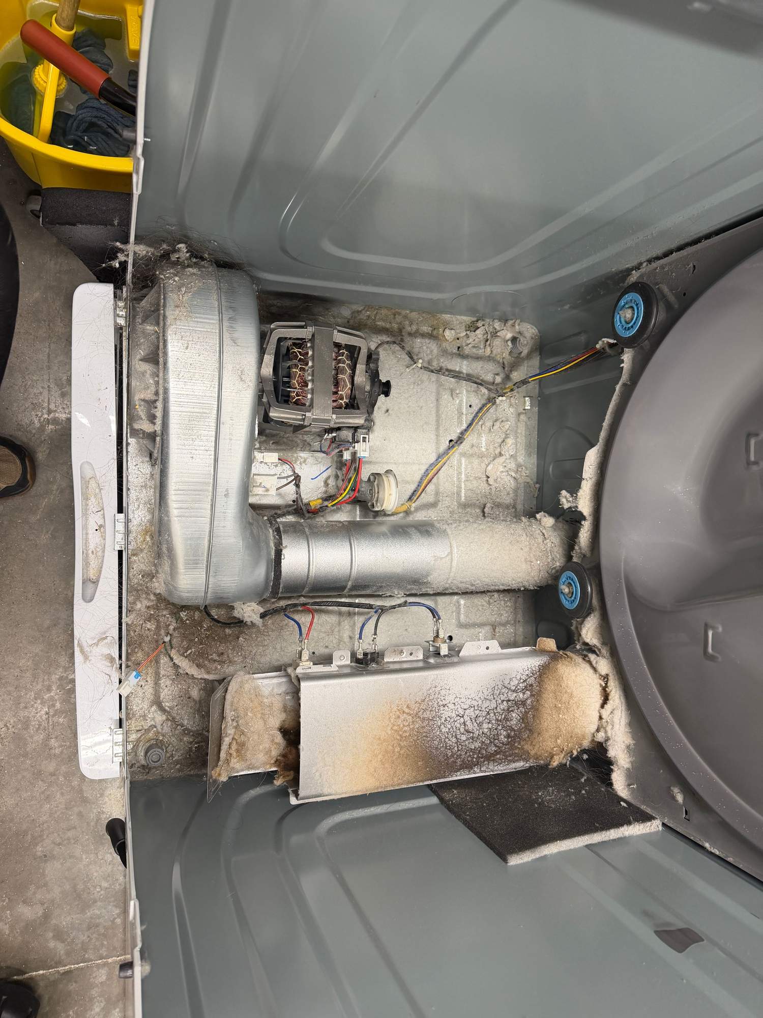 Inside a dryer cavity packed with lint buildup from a restricted vent