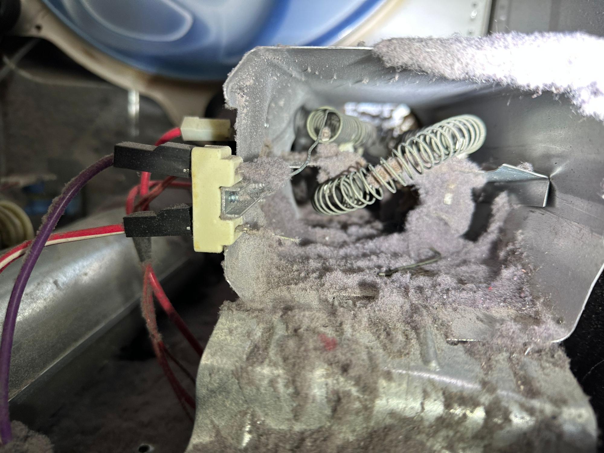 Dryer heating element area packed with lint from a restricted vent, a fire hazard