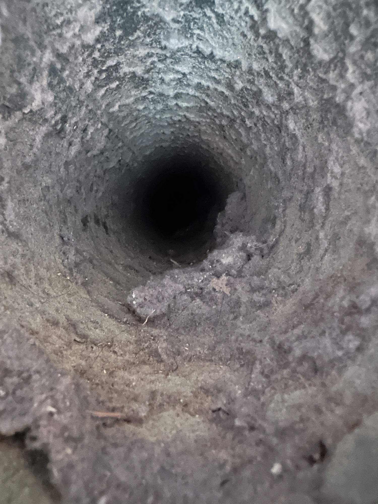 Dryer vent clogged with lint buildup, before cleaning