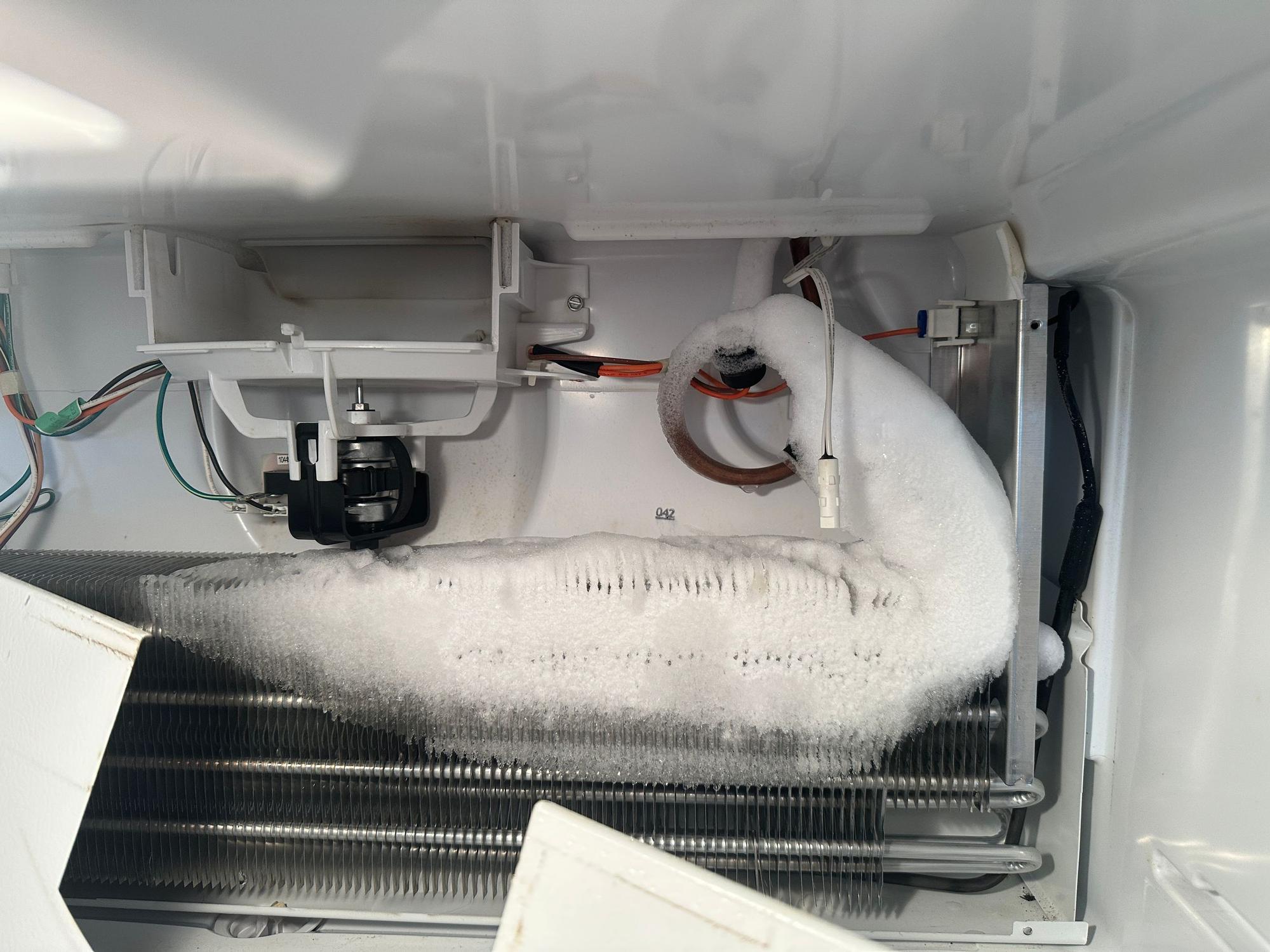 Evaporator coil covered in frost and ice. This is what a defrost system failure looks like